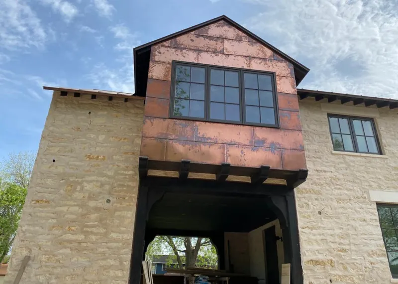 Copper metal panel facade on a stone building for Metal Roof Coating in Downey